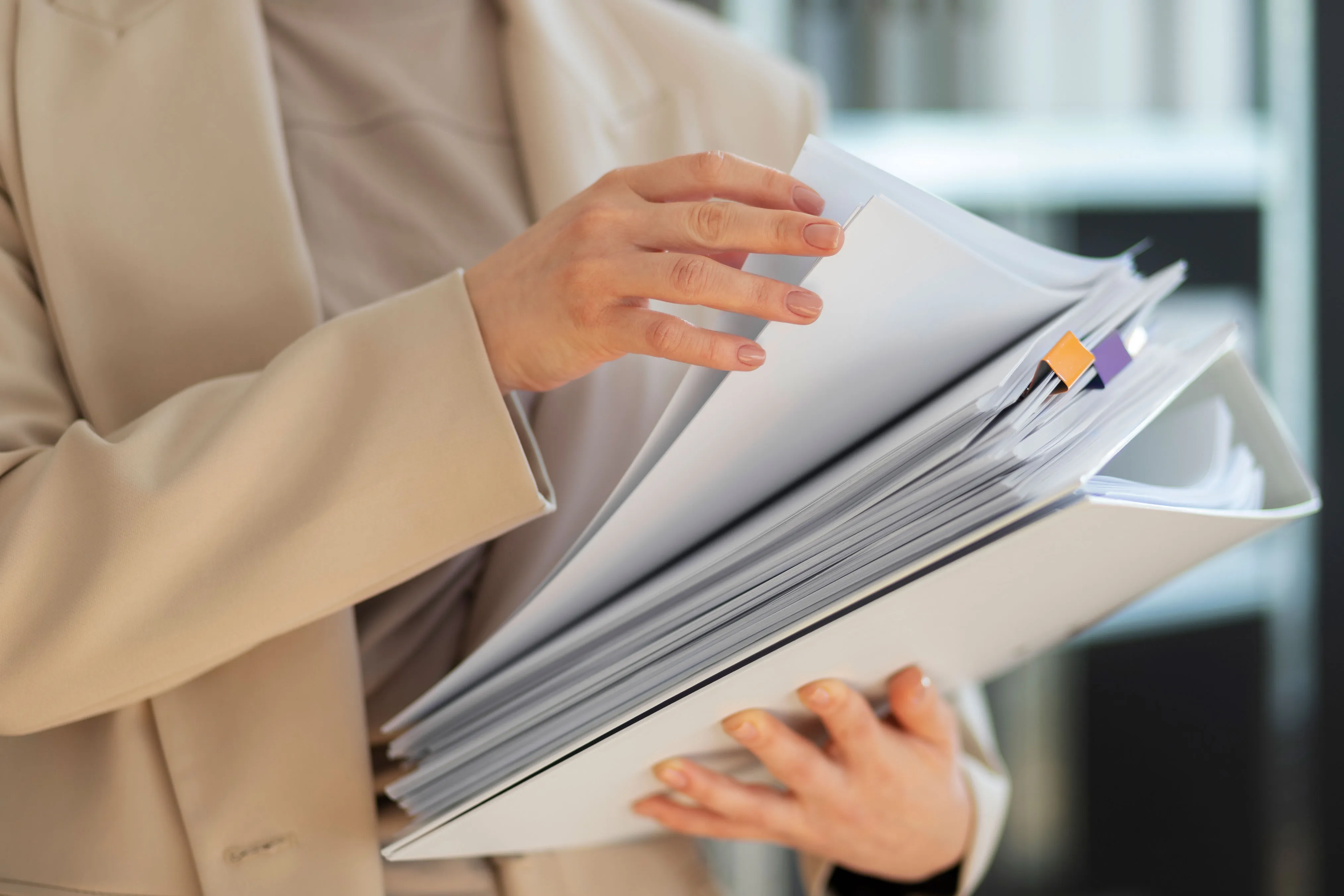 Person sorting documents to represent six capital services separated by purpose.