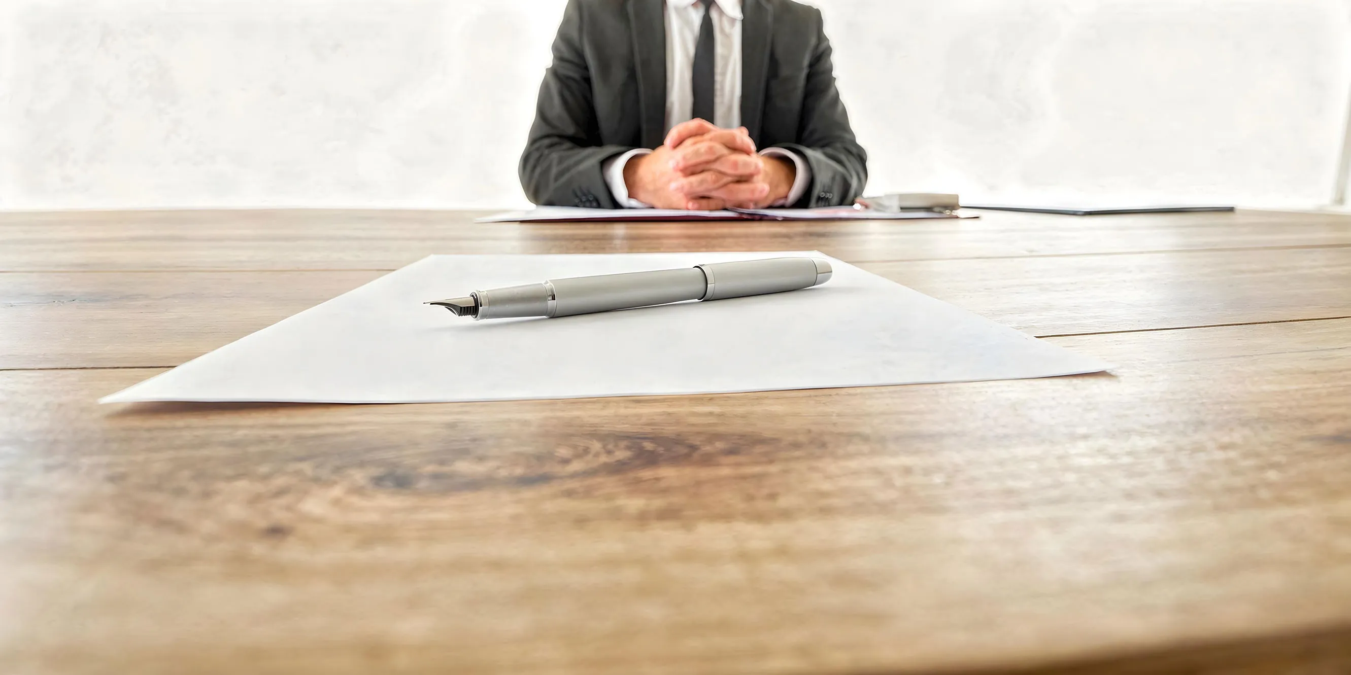 Pen and blank paper before a meeting for settling the role of proceeds after a liquidity event.